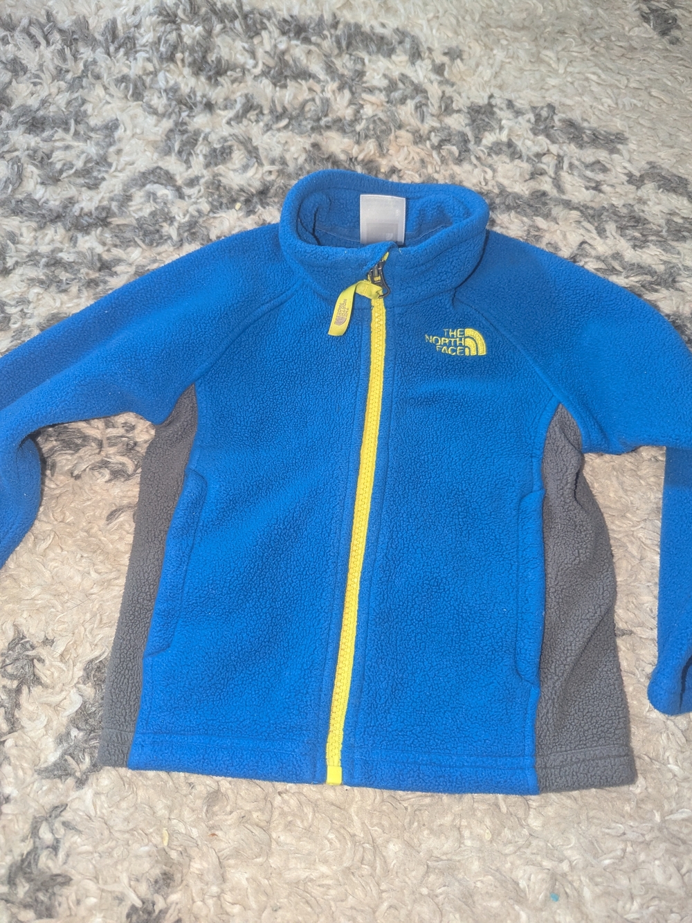The North Face Kids Blue Fleece Jacket with Gray Panels and Yellow Zip